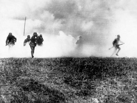 Black and white image of soldiers bursting through a large cloud.